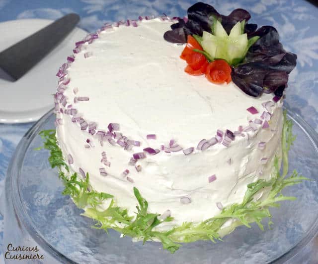 A Swedish Sandwich Cake is the perfect centerpiece for a spring party. Bright, fresh, and fun to prepare, make this recipe for your next picnic! | www.CuriousCuisiniere.com