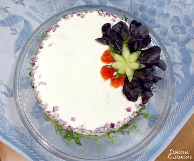 A Swedish Sandwich Cake is the perfect centerpiece for a spring party. Bright, fresh, and fun to prepare, make this recipe for your next picnic! | www.CuriousCuisiniere.com