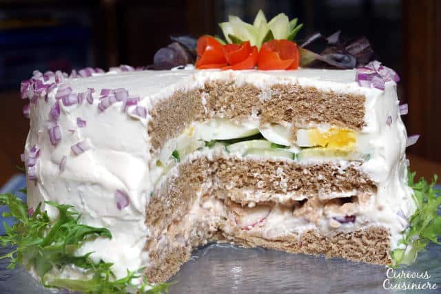 A Swedish Sandwich Cake is the perfect centerpiece for a spring party. Bright, fresh, and fun to prepare, make this recipe for your next picnic! | www.CuriousCuisiniere.com