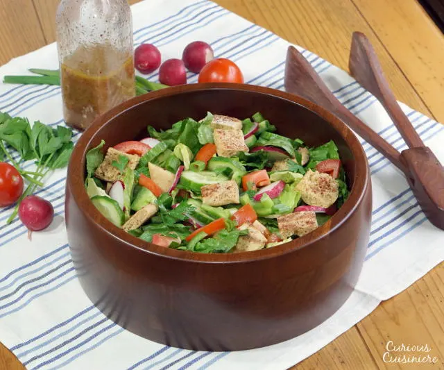 With toasted pita bread and a bright, lemony dressing, this crisp Fattoush Salad recipes is sure to bring a ray of sunshine to any spring or summer table. | www.CuriousCuisiniere.com