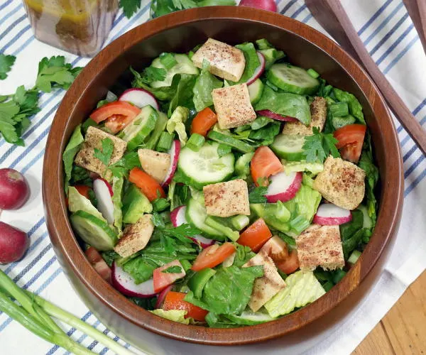With toasted pita bread and a bright, lemony dressing, this crisp Fattoush Salad recipes is sure to bring a ray of sunshine to any spring or summer table. | www.CuriousCuisiniere.com