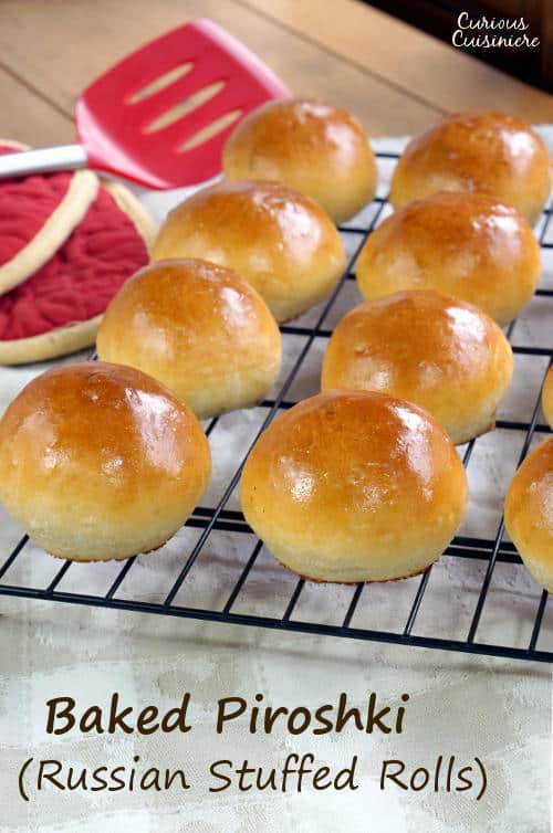 Soft and fluffy dinner rolls stuffed with a savory filling, Baked Russian Piroshki are the perfect portable meal. | www.CuriousCuisiniere.com