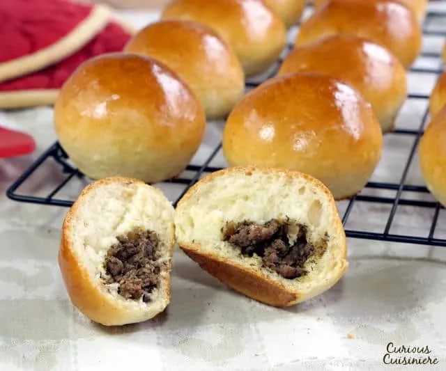 Soft and fluffy dinner rolls stuffed with a savory filling, Baked Russian Piroshki are the perfect portable meal. | www.CuriousCuisiniere.com