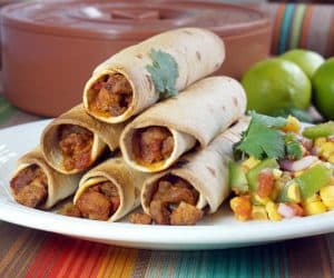 Baked Flautas combine a crisp flour tortilla shell with a flavorful pork filling to create a lighter version of this classic snack. | www.CuriousCuisiniere.com