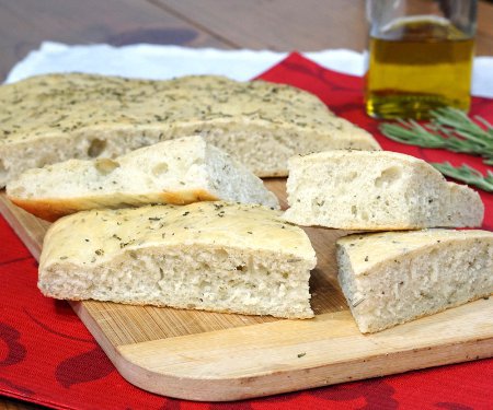 This soft, chewy Focaccia bread is flavored with rosemary and sea salt. It is perfect for serving as an appetizer or along side a pasta dinner! | www.CuriousCuisiniere.com