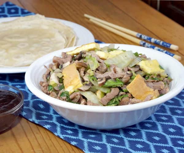 Moo Shu Pork is a traditional Chinese stir fry dish of pork, eggs, and mushrooms. This easy version comes together in a matter of minutes, making this recipe perfect for a weeknight dinner. | www.CuriousCuisiniere.com