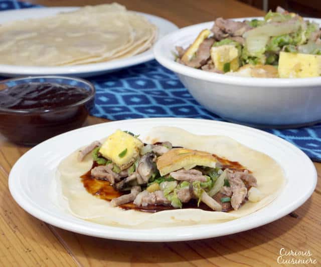 Moo Shu Pork is a traditional Chinese stir fry dish of pork, eggs, and mushrooms. This easy version comes together in a matter of minutes, making this recipe perfect for a weeknight dinner. | www.CuriousCuisiniere.com