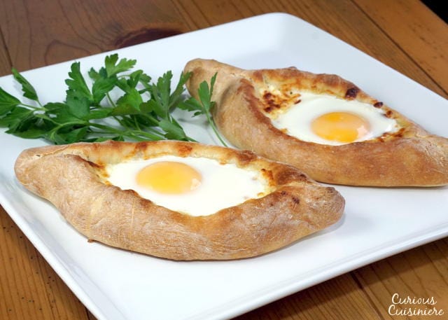 Adjaruli Khachapuri (Georgian Cheese Bread) on a large white platter