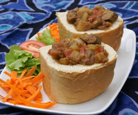 Bunny chow is a unique South African street food made up of a spicy curry served in a hollowed out loaf of bread. | www.CuriousCuisiniere.com
