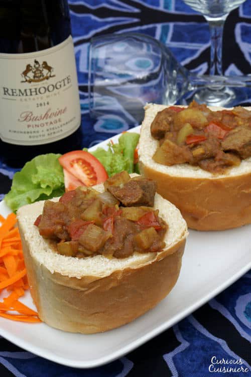 Bunny chow is a unique South African street food made up of a spicy curry served in a hollowed out loaf of bread. | www.CuriousCuisiniere.com