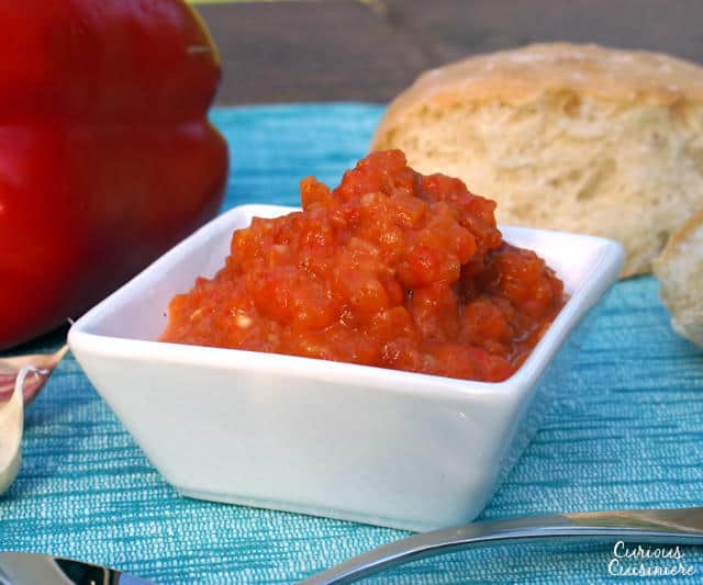 Get ready to fall in love with grill-roasted red peppers. One bite of Ajvar, and you will want to put this Serbian red pepper relish on everything from bread to meat and even veggies!| www.CuriousCuisiniere.com