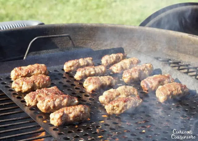 Cevapi are easy to make, grilled sausages from Southeastern Europe that burst with smoky flavor and are perfect for serving with flatbread and sliced onions. | www.CuriousCuisiniere.com