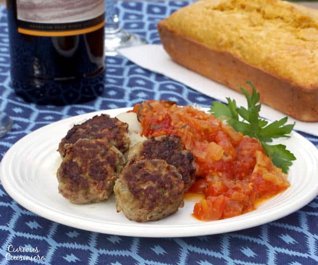 Frikkadel are a lightly spiced South African meatball that are often served with a sweet and herby tomato sauce, making a wonderfully comforting dinner that pairs perfectly with a South African Cabernet Sauvignon. | www.CuriousCuisiniere.com