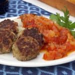 Frikkadel are a lightly spiced South African meatball that are often served with a sweet and herby tomato sauce, making a wonderfully comforting dinner that pairs perfectly with a South African Cabernet Sauvignon. | www.CuriousCuisiniere.com