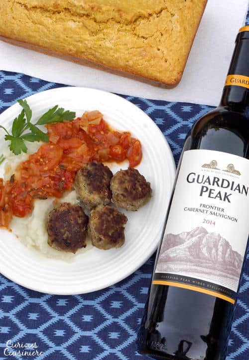 Frikkadel are a lightly spiced South African meatball that are often served with a sweet and herby tomato sauce, making a wonderfully comforting dinner that pairs perfectly with a South African Cabernet Sauvignon. | www.CuriousCuisiniere.com