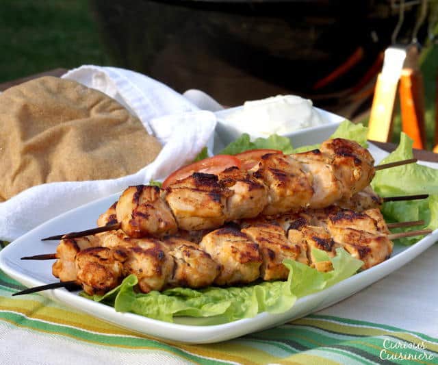 Lemon and garlic bring a burst of flavor to these grilled chicken skewers. Middle Eastern Shish Tawook will make a great addition to your next cookout! | www.CuriousCuisiniere.com