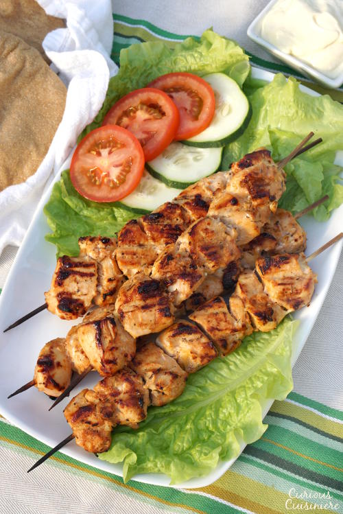 Lemon and garlic bring a burst of flavor to these grilled chicken skewers. Middle Eastern Shish Tawook will make a great addition to your next cookout! | www.CuriousCuisiniere.com