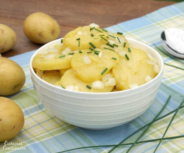 Tangy and sweet Schwabischer Kartoffelsalat, is flavorful German Potato Salad, perfect for your next cookout or picnic, or for celebrating Oktoberfest. | www.CuriousCuisiniere.com