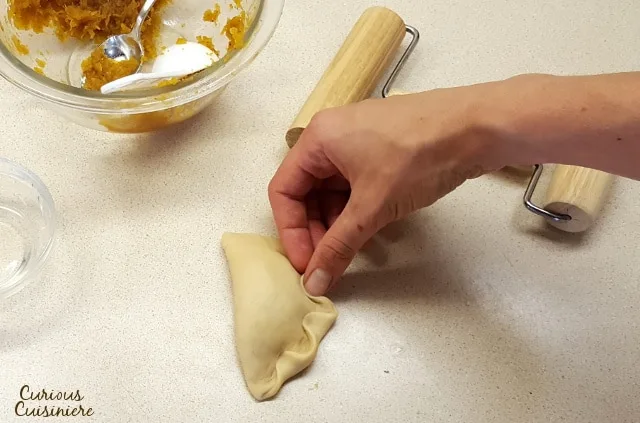 Lightly sweet and full of pumpkin pie flavor, these Baked Pumpkin Empanadas are a fun treat for any pumpkin lover! | www.CuriousCuisiniere.com