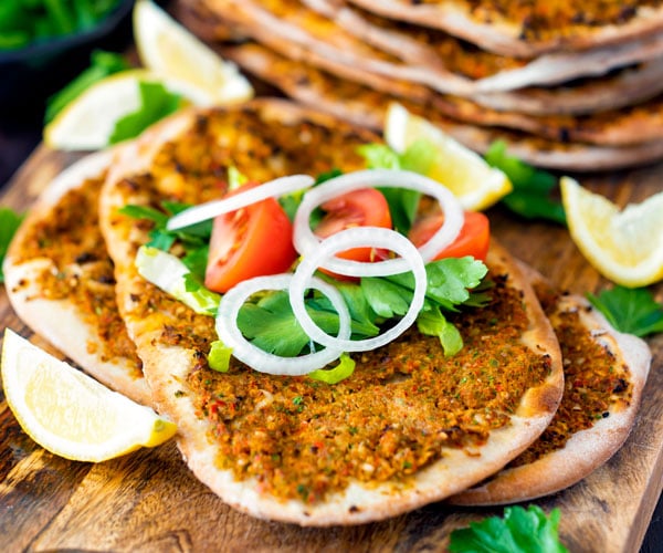 Lahmacun - Turkish Pizza - Thin and crispy pizza topped with a meat and vegetable mixture and rolled with fresh toppings. A perfect street food!