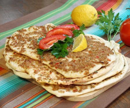Crispy, flatbread Turkish pizza, Lahmacun, is fun to eat and a great recipe for a party, since everyone can top their own as they desire. | Curious Cuisiniere