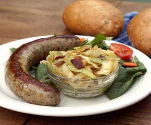 Our Kapusta recipe transforms simple cabbage into a flavorful Polish side dish that is studded with bacon! | www.CuriousCuisiniere.com