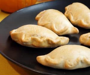 Lightly sweet and full of pumpkin pie flavor, these Baked Pumpkin Empanadas are a fun treat for any pumpkin lover! | www.CuriousCuisiniere.com