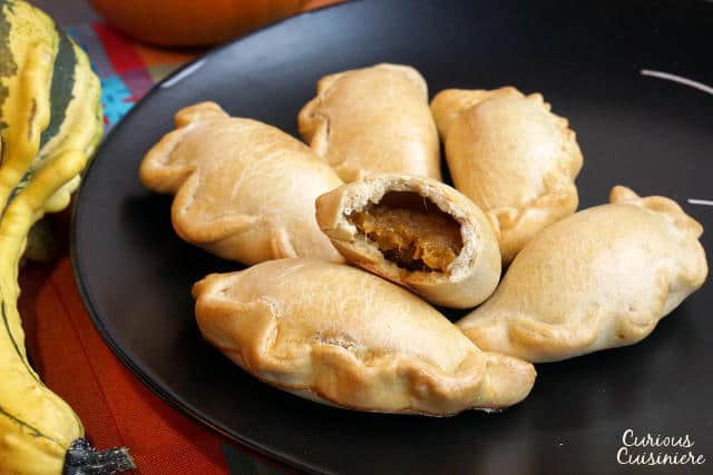 Lightly sweet and full of pumpkin pie flavor, these Baked Pumpkin Empanadas are a fun treat for any pumpkin lover! | www.CuriousCuisiniere.com