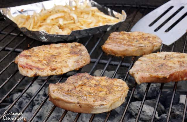 In western Germany you find a fun grilling tradition known as 'Schwenker'. These juicy, smoky grilled German pork chops are cooked on a swinging grill! | www.CuriousCuisiniere.com