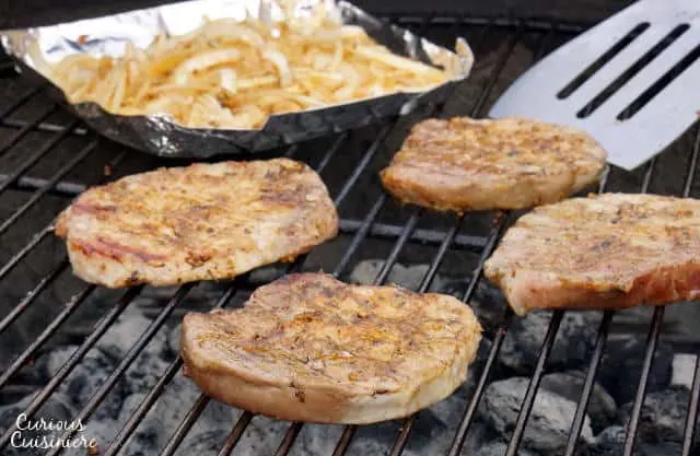 In western Germany you find a fun grilling tradition known as 'Schwenker'. These juicy, smoky grilled German pork chops are cooked on a swinging grill! | www.CuriousCuisiniere.com