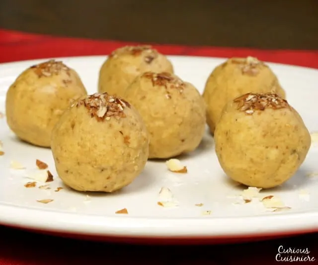 It's easy to make these nutty and sweet, no bake Indian chickpea treats. Besan Ladoo are a perfect gluten free treat to add to a cookie platter! | www.CuriousCuisiniere.com