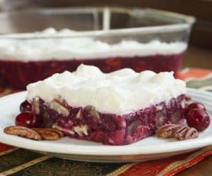 Chock full of crunchy pecans and tart cranberries this Pecan Cranberry Jello Salad proves that your holiday cranberries don't have to be ordinary. | Curious Cuisiniere