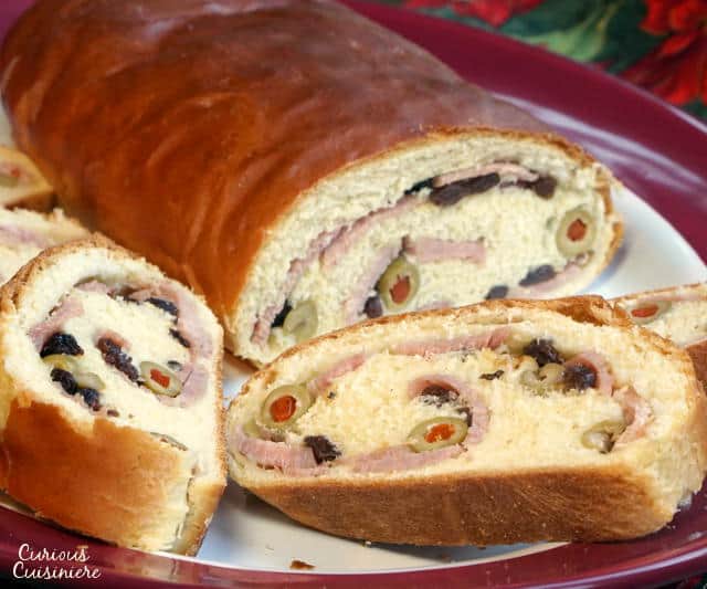 Pan de Jamon is a traditional Venezuelan Christmas bread filled with ham and olives. Its robust flavors are a unique tribute to Venezuelan culture. | www.CuriousCuisiniere.com