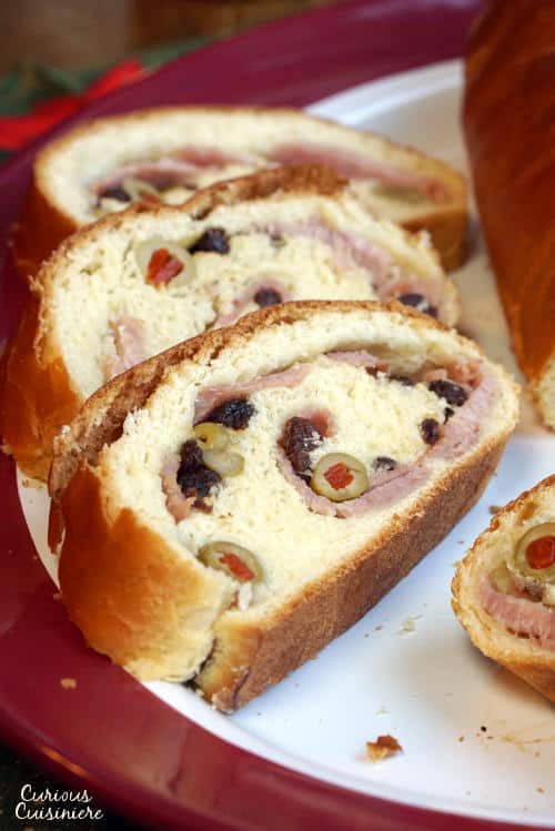 Pan de Jamon is a traditional Venezuelan Christmas bread filled with ham and olives. Its robust flavors are a unique tribute to Venezuelan culture. | www.CuriousCuisiniere.com