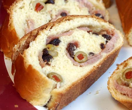 Pan de Jamon is a traditional Venezuelan Christmas bread filled with ham and olives. Its robust flavors are a unique tribute to Venezuelan culture. | www.CuriousCuisiniere.com