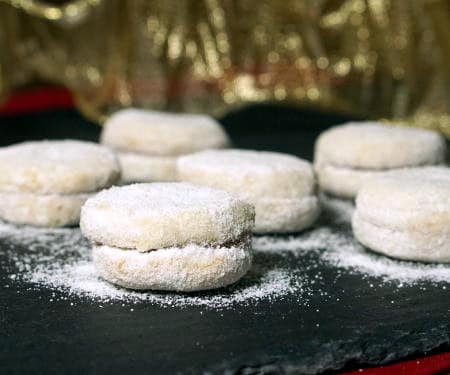 Vanilice are bite-sized Serbian Vanilla Cookies that are seriously addicting. With a nutty sweetness and a soft jam filling, they're the perfect recipe to add to your next cookie platter! | www.CuriousCuisiniere.com