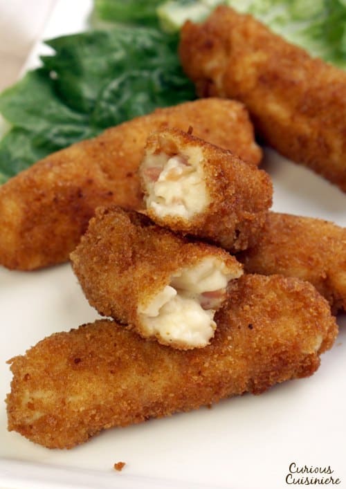 Perfect for game day or any appetizer party, Croquetas de Jamon are tasty Spanish Ham Croquettes that are filled, not with potatoes, but with a creamy bechamel sauce. | www.CuriousCuisiniere.com