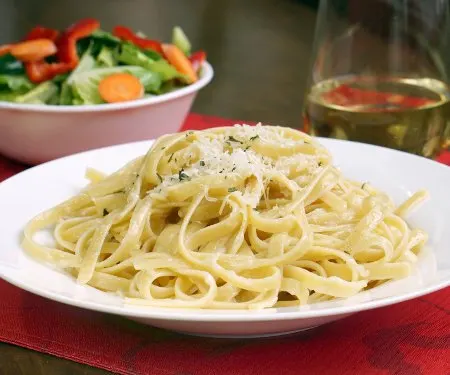 Three ingredients is all you need for authentic Fettuccine Alfredo. It's a dish that just goes to show you can't beat simplicity! | www.CuriousCuisiniere.com