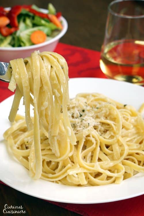 Three ingredients is all you need for authentic Fettuccine Alfredo. It's a dish that just goes to show you can't beat simplicity! | www.CuriousCuisiniere.com