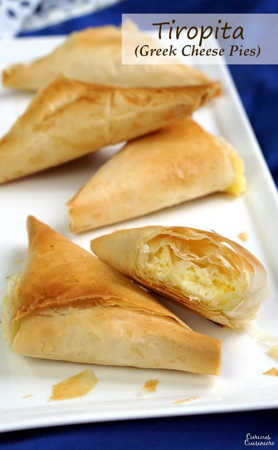 Light and flaky Greek pies filled with feta cheese, Tiropita make for a wonderful appetizer or snack that everyone is sure to enjoy! | www.CuriousCuisiniere.com