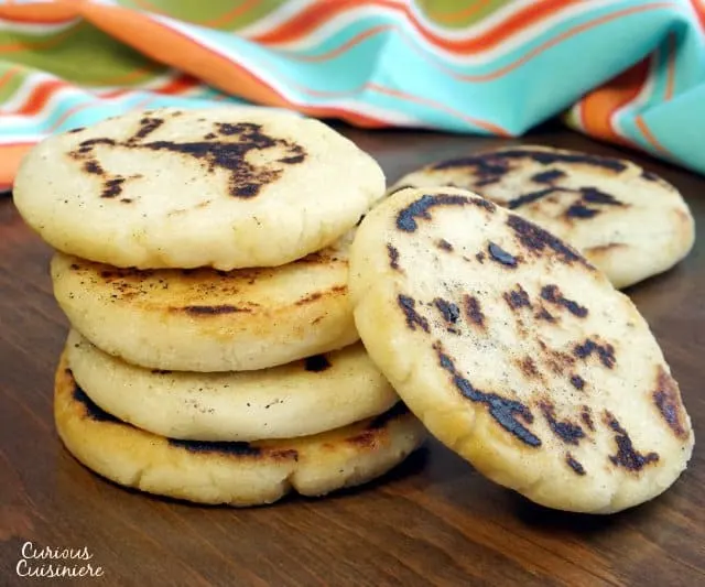 Whether you've wondered how to make arepas or you've never heard of them before, you're sure to fall in love with these easy and versatile South American corn bread rounds! | www.CuriousCuisiniere.com