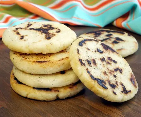 Whether you've wondered how to make arepas or you've never heard of them before, you're sure to fall in love with these easy and versatile South American corn bread rounds! | www.CuriousCuisiniere.com