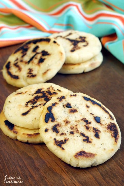 Whether you've wondered how to make arepas or you've never heard of them before, you're sure to fall in love with these easy and versatile South American corn bread rounds! | www.CuriousCuisiniere.com