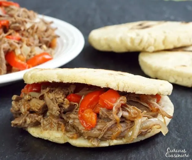 Whether you've wondered how to make arepas or you've never heard of them before, you're sure to fall in love with these easy and versatile South American corn bread rounds! | www.CuriousCuisiniere.com