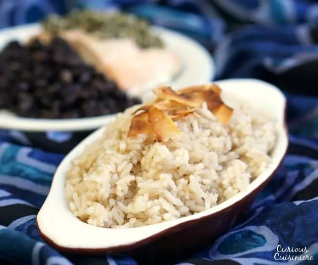 Savory and sweet Arroz con Coco is a wonderfully flavorful Colombian Coconut Rice side dish that you will soon find yourself addicted to! | www.CuriousCuisiniere.com