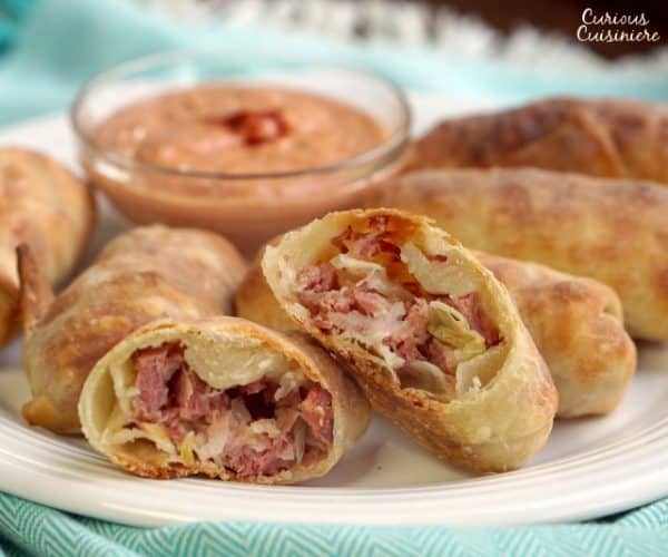 All the flavor of a Reuben sandwich in a little hand-held appetizer, these Baked Reuben Egg Rolls are the perfect recipe for a St. Patrick's Day party or any party! | www.CuriousCuisiniere.com
