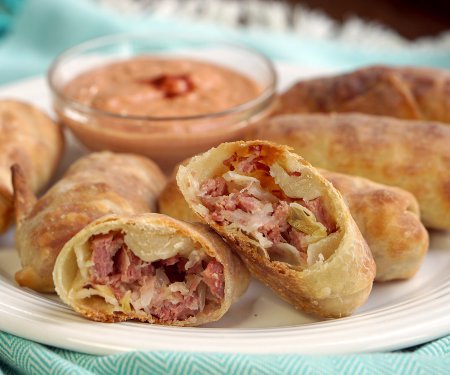 All the flavor of a Reuben sandwich in a little hand-held appetizer, these Baked Reuben Egg Rolls are the perfect recipe for a St. Patrick's Day party or any party! | www.CuriousCuisiniere.com