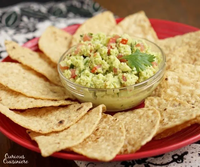 If you've never made guacamole from scratch, you'll be surprised how fun our Authentic Easy Guacamole recipe is. With just a few ingredients, you can be dipping away! | www.CuriousCuisiniere.com