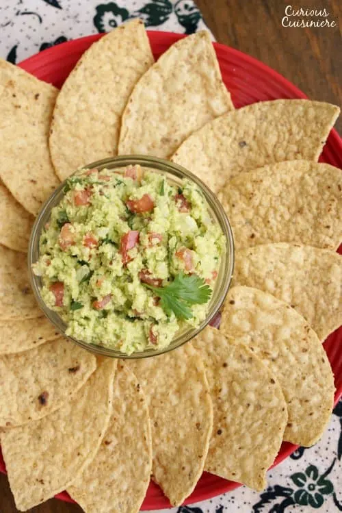 If you've never made guacamole from scratch, you'll be surprised how fun our Authentic Easy Guacamole recipe is. With just a few ingredients, you can be dipping away! | www.CuriousCuisiniere.com