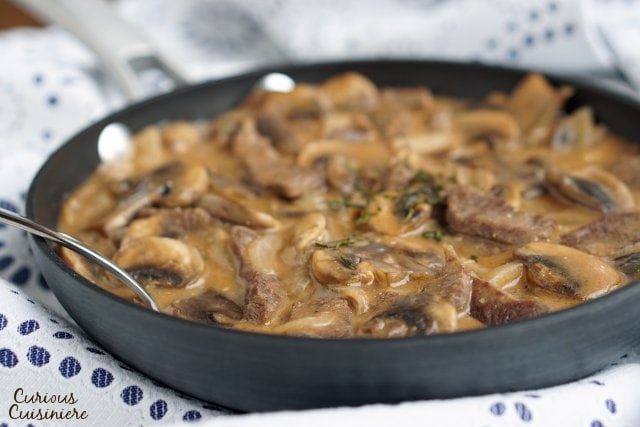 Beef Strogonoff is so much more than the 50s and 60s made it out to be. Our easy and authentic Russian Beef Stroganoff recipe combines tender beef and flavorful mushrooms in a creamy sauce for an elegant, yet quick dish. | www.CuriousCuisiniere.com 
